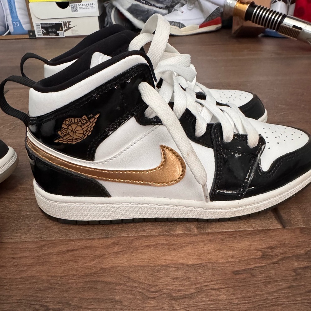 Size 2 Jordans black and gold - gently used good condition